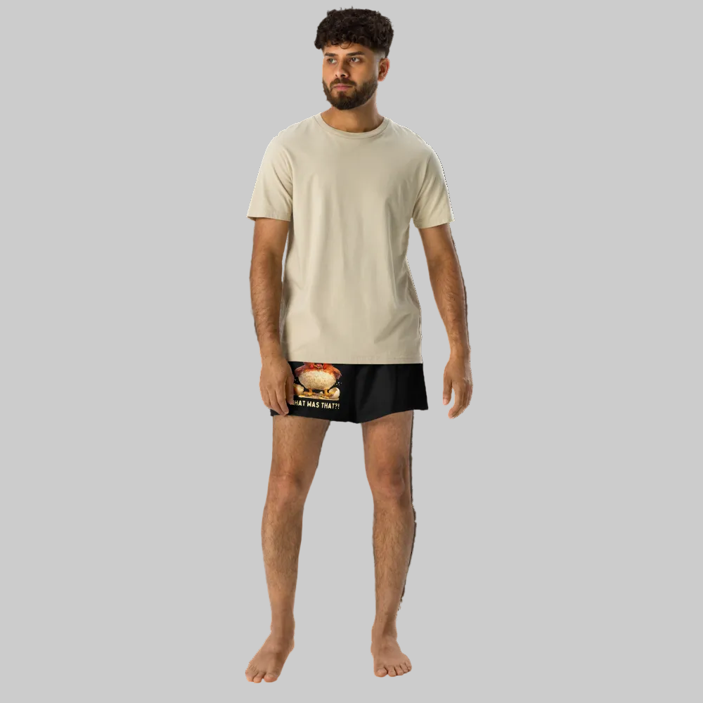 Man wearing a beige t-shirt and black underwear with graphic design on a white background